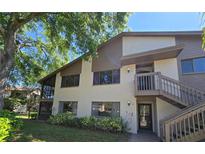 Two-story condo featuring a screened patio, private entrance, and well-maintained landscaping at 12809 Wedgewood Way # A, Hudson, FL 34667