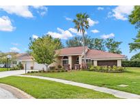 Beautiful single-story home featuring a red tile roof and lush landscaping at 3014 Ashland Ter, Clearwater, FL 33761