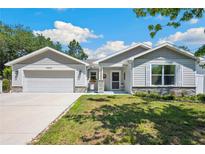 Charming single-Gathering home with well-maintained lawn, beautiful landscaping, and a two-car garage at 37673 Dixie Ave, Dade City, FL 33525
