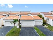 Charming townhomes featuring two-car garages, neutral paint and desert landscaping offer curb appeal at 4306 Sunray Ct, Tampa, FL 33615