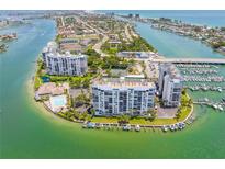 Stunning aerial view of waterfront condos with marina, pool, and Intracoastal Waterway access at 9495 Blind Pass Rd # 406, St Pete Beach, FL 33706