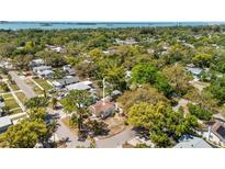 Charming single-Gathering home nestled among lush trees in a quiet residential neighborhood with water views in the distance at 1232 Sedeeva S Cir, Clearwater, FL 33755