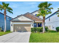 Charming two-story home with a stone accent, well-manicured lawn, and a two-car garage at 1476 Fort Cobb Ter, Wesley Chapel, FL 33543