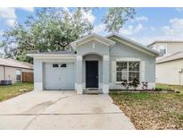 Charming single-Gathering home featuring an attached garage and inviting front entrance at 1524 Marsh Wood Dr, Seffner, FL 33584