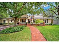 Inviting home with a charming brick pathway, lush landscaping, and a cozy front porch at 3408 W San Jose St, Tampa, FL 33629