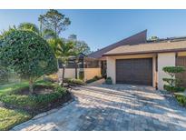 Charming home with lush landscaping and a private garage on a sunny day at 5010 Umber N Way, Tampa, FL 33624