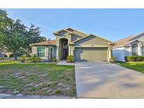 Charming single-Gathering home featuring a two-car garage and well-maintained landscaping at 6933 Waterbrook Ct, Gibsonton, FL 33534