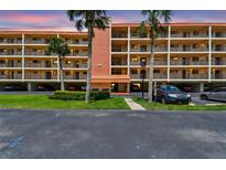 Beautiful condo complex featuring well-maintained landscaping and a view of the sunset at 9450 Harbor Greens Way # 403, Seminole, FL 33776