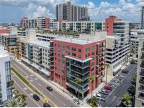 A vibrant city scene featuring modern, colorful apartment buildings and convenient street parking at 1208 E Kennedy Blvd # 1125, Tampa, FL 33602