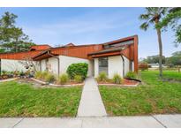 Charming one-story home with beautiful wood accents and a well-maintained front yard at 2070 Sunset Point Rd # 111, Clearwater, FL 33765