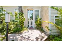 Inviting front entrance with modern windows, mature landscaping and a welcoming walkway at 6014 Luana S Ln, Gulfport, FL 33707