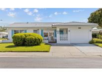 Charming single-story home featuring a well-manicured lawn and a one-car garage at 10155 36Th N Way, Pinellas Park, FL 33782