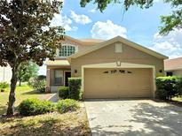 Charming two-story home with a two-car garage and well-maintained landscaping at 12604 Montford Ln, Riverview, FL 33579