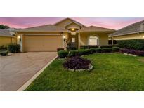 Charming single-Gathering home featuring a well-manicured lawn and a two-car garage at 17425 Eagle Trace Dr, Brooksville, FL 34604