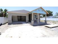 New construction features an attached garage, covered porch with columns, and a neutral color palette at 4244 11Th N Ave, St Petersburg, FL 33713
