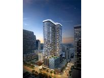 Stunning exterior view of the modern One Tampa high-rise building against the night sky at 520 N Tampa St # 1508, Tampa, FL 33602