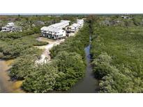 Beautiful aerial view of waterfront townhomes surrounded by lush mangrove forests and a tranquil waterway at 1500 Sunset Rd # C7, Tarpon Springs, FL 34689