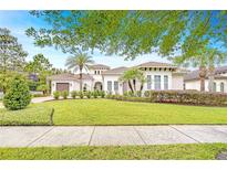 Charming single-story home featuring a well-manicured lawn and lush landscaping, set beneath a clear blue sky at 15305 Fishhawk Preserve Dr, Lithia, FL 33547