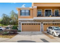 A charming multi-story home with a two-car garage, stone accents, and a balcony on the second floor at 16621 Kingletside Ct, Lithia, FL 33547
