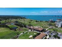 Breathtaking aerial view showcases the golf course, waterfront, and surrounding residential area at 220 Belleview Blvd # 104, Belleair, FL 33756