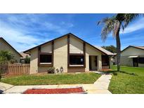 Charming home featuring a well-manicured lawn and decorative mulch bed at 2459 Bay Berry Dr, Clearwater, FL 33763
