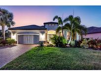 Stunning single-story home featuring a well-manicured lawn, beautiful landscaping and a two-car garage at 4506 Stickley Ct, Palmetto, FL 34221