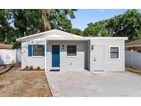 Charming home featuring blue shutters, a matching blue door, and a well-maintained front yard at 5111 N 30Th St, Tampa, FL 33610