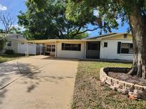 Charming single-story home with a carport and landscaped yard, offering a cozy and inviting curb appeal at 6012 Frond Way, Apollo Beach, FL 33572
