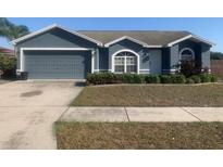 Charming single-story home with a well-maintained lawn, a two-car garage and manicured landscaping at 10540 Carloway Hills Dr, Wimauma, FL 33598