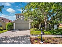 Charming two-story home featuring a well-manicured lawn and a two-car garage at 11519 Cypress Reserve Dr, Tampa, FL 33626