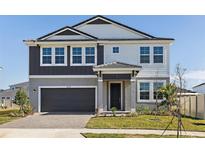 Charming two-story home featuring a two-car garage and well-manicured landscaping at 12170 Cattleside Dr, Riverview, FL 33579