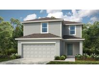 Charming two-story home with gray siding and a well-manicured lawn at 12414 Gust Ct, Hudson, FL 34669