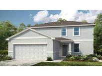 Charming two-story home showcasing a two-car garage, blue door and lush landscaping at 13470 Tropical Breeze Way, Hudson, FL 34669