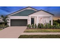 Charming single-Gathering home with a two-car garage, manicured lawn and inviting covered porch at 14427 Meadow Bird Ave, Riverview, FL 33579