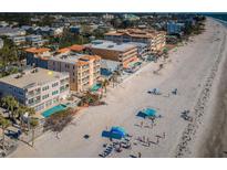 Coastal condominiums boast private pools and beach access on a sunny day, enhancing the allure of beachfront living at 3 7Th Ave # 3, Indian Rocks Beach, FL 33785