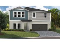 New construction home featuring a two-car garage, neutral color scheme, and an inviting front yard at 37073 Sagemoor Dr, Zephyrhills, FL 33541