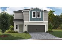 Charming two-story home with a two-car garage and a well-manicured lawn at 37128 Sagemoor Dr, Zephyrhills, FL 33541