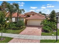 Beautiful single Gathering home with a tile roof, two-car garage and a red brick driveway at 4917 Sandy Brook Crk, Wimauma, FL 33598
