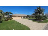Charming single-story home with a paver driveway and well-manicured lawn at 781 Binnacle Point Dr, Longboat Key, FL 34228