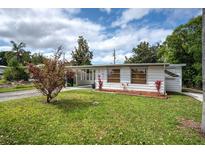 Charming single-story home featuring a covered carport and well-maintained lawn in a residential neighborhood at 10275 117Th Dr, Largo, FL 33773