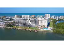 Waterfront condo building with docks, pool, and ocean views at 19451 Gulf Blvd # 211, Indian Shores, FL 33785