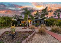 Charming home with a well-manicured front yard, mature landscaping, and a cozy, inviting entrance at 230 32Nd N Ave, St Petersburg, FL 33704