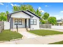 Charming home featuring a manicured lawn, light stone walkway, and welcoming front porch at 2511 W Braddock St, Tampa, FL 33607