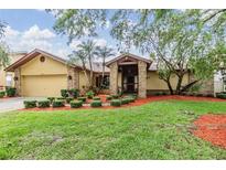 Charming single-story home with well-maintained landscaping, colorful mulch, and inviting entrance with brick pillars at 2664 Frisco Dr, Clearwater, FL 33761
