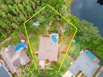 Aerial shot of a property surrounded by a perimeter outlined in yellow and including a private pool at 3728 Cypress Meadows Rd, Tampa, FL 33624