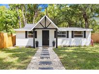 Charming home featuring black trim, a stone walkway, and a well-manicured lawn at 37401 Magnolia Ave, Dade City, FL 33523
