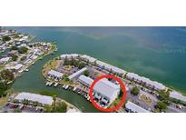 Aerial view of waterfront condos with docks and canal access to the ocean at 4799 Coquina Key Se Dr, St Petersburg, FL 33705