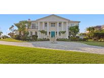 Stately two-story home featuring a circular drive and classic architectural details, perfect for luxury living at 6106 Marbella Blvd, Apollo Beach, FL 33572