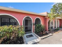 Inviting single-story home featuring an arched entryway, well-maintained landscaping and a tranquil and private setting at 6408 Bonnie Bay N Cir, Pinellas Park, FL 33781