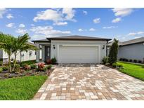 Charming single-Gathering home with a two-car garage and beautifully landscaped front yard at 9408 Coastline Way, Parrish, FL 34219